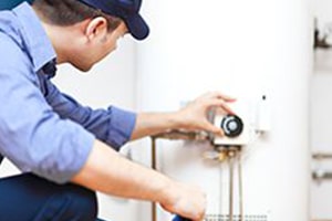 Plumber Fixing Hot Water Thermostat for Hot Water System