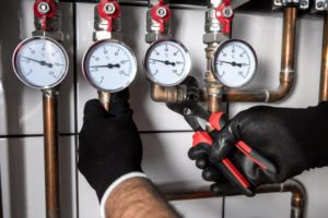 Plumber Fixing Central Heating System