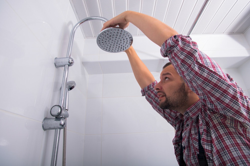 Professional Plumber Repairing A Shower Head